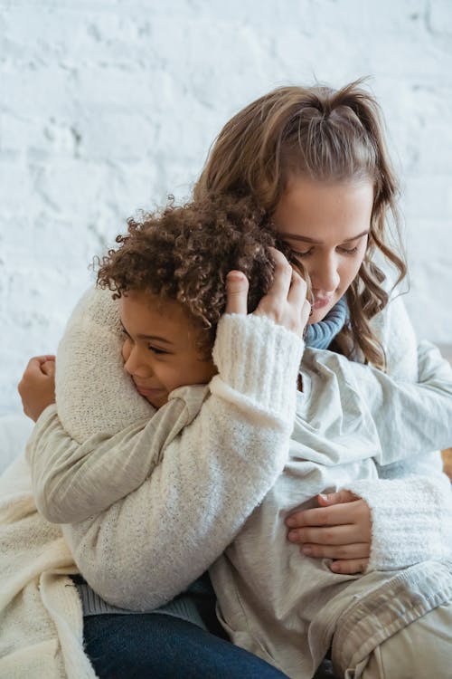 young woman hugging child