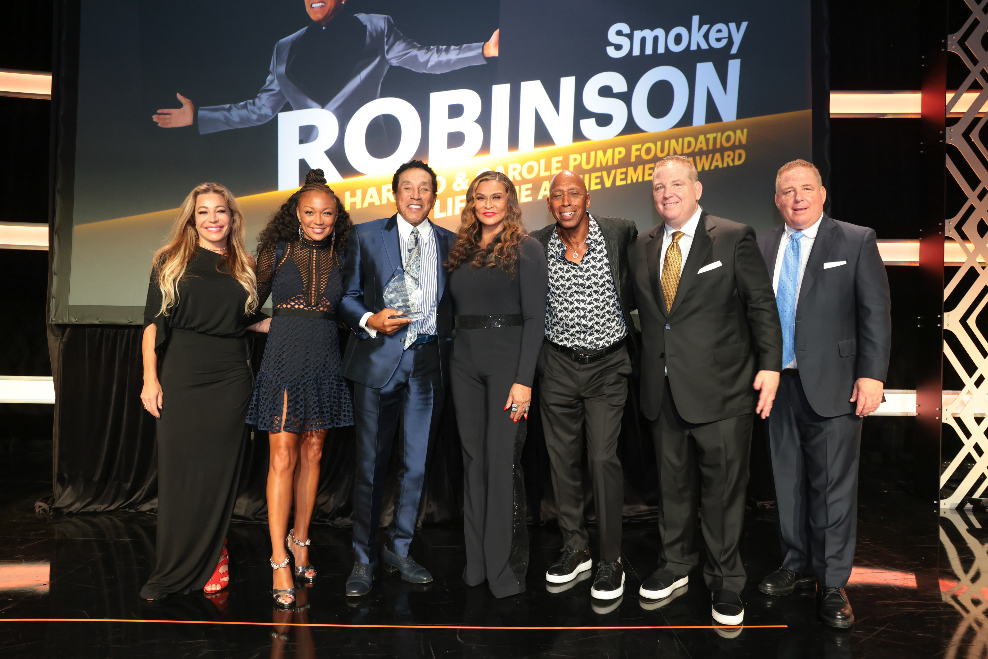 Smokey Robinson on stage with group